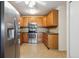 Efficient kitchen with stainless steel appliances and wood cabinets for a functional cooking space at 725 S Alton Way # 7D, Denver, CO 80247