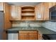 Functional kitchen with stainless steel dishwasher, sink, tile backsplash and open shelving at 725 S Alton Way # 7D, Denver, CO 80247