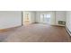 Spacious living room with neutral carpeting and sliding glass doors at 725 S Alton Way # 7D, Denver, CO 80247