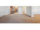 Spacious living room with neutral carpet and easy access to the kitchen with stainless steel appliances at 725 S Alton Way # 7D, Denver, CO 80247