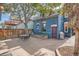 Quaint backyard with a patio, outdoor grill, mature tree, and unique blue siding at 209 S Lincoln St, Denver, CO 80209