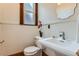 Charming powder room features pedestal sink, updated fixtures and a quaint window at 209 S Lincoln St, Denver, CO 80209