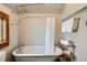 Bathroom featuring clawfoot tub, chrome shower fixtures, and a vanity window with natural light at 209 S Lincoln St, Denver, CO 80209