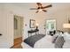 Bright bedroom featuring hardwood floors, a ceiling fan, and modern decor at 209 S Lincoln St, Denver, CO 80209