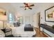 Cozy bedroom featuring natural light, hardwood floors, ceiling fan, and a neutral color palette at 209 S Lincoln St, Denver, CO 80209