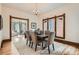 Stylish dining room connected to the living room, with a large table and windows overlooking the neighborhood at 209 S Lincoln St, Denver, CO 80209