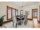 Formal dining room with classic trim, a chandelier, and large windows providing natural light at 209 S Lincoln St, Denver, CO 80209