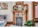 Close-up view of the ornate fireplace with decorative tiles, wood mantel, and elegant detailing at 209 S Lincoln St, Denver, CO 80209