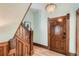 Elegant foyer with a decorative wooden staircase, a unique door, and chandelier lighting at 209 S Lincoln St, Denver, CO 80209