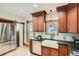 Updated kitchen with wood cabinets, stainless steel appliances, and a farmhouse sink under a pendant light at 209 S Lincoln St, Denver, CO 80209