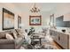 Cozy living room with modern decor, patterned rug, and large windows bringing in ample light at 209 S Lincoln St, Denver, CO 80209