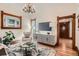 The living room with warm wood trim, modern furniture, and a decorative chandelier at 209 S Lincoln St, Denver, CO 80209