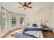 Bright main bedroom with large windows, ceiling fan and hardwood floors, bathed in natural light at 209 S Lincoln St, Denver, CO 80209