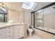 Bright bathroom with a skylight over the tub and shower combo and gray tiling at 1300 S Monaco Pkwy # 12, Denver, CO 80224