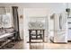 Eating space with farmhouse style table, hardwood floors, adjacent to kitchen and living room at 1300 S Monaco Pkwy # 12, Denver, CO 80224