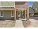 Close-up of the building entrance, number 1300, with brick pillars and sidewalk at 1300 S Monaco Pkwy # 12, Denver, CO 80224