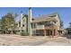 View of Ashley Court building showcasing green siding and brick facade at 1300 S Monaco Pkwy # 12, Denver, CO 80224