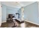 Home gym with light blue walls, featuring a treadmill and rowing machine at 1300 S Monaco Pkwy # 12, Denver, CO 80224