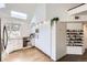Modern kitchen featuring skylights, sleek white cabinets, and stainless steel appliances at 1300 S Monaco Pkwy # 12, Denver, CO 80224