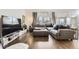 Cozy living room with hardwood flooring, comfortable seating, and a large TV at 1300 S Monaco Pkwy # 12, Denver, CO 80224
