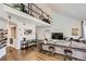 Open-concept living room with loft, hardwood floors, and modern decor at 1300 S Monaco Pkwy # 12, Denver, CO 80224