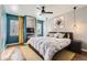 Stylish main bedroom featuring a fireplace, modern art, and ample natural light at 1300 S Monaco Pkwy # 12, Denver, CO 80224