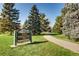Inviting park entrance with manicured lawn and paved pathway for outdoor enjoyment at 1300 S Monaco Pkwy # 12, Denver, CO 80224