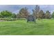 Sign for David T. Garland SR Park, surrounded by green grass and trees on a cloudy day at 1300 S Monaco Pkwy # 12, Denver, CO 80224