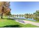 A serene pond view with a walking path and bench seating offers a relaxing outdoor experience at 1300 S Monaco Pkwy # 12, Denver, CO 80224
