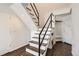 A modern staircase with dark wood steps and black metal railing at 1300 S Monaco Pkwy # 12, Denver, CO 80224