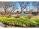 Well-maintained tennis court surrounded by lush greenery, providing a private and active space at 1300 S Monaco Pkwy # 12, Denver, CO 80224