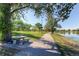 Scenic walking path featuring lush green spaces, mature trees, and tranquil water views at 1300 S Monaco Pkwy # 12, Denver, CO 80224