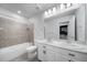 Well-lit bathroom features double sinks, large mirror, and tiled shower-tub, offering both style and functionality at 18189 House Finch Ln, Parker, CO 80134