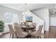 Elegant dining room featuring a round table with seating for six and natural light from nearby window at 18189 House Finch Ln, Parker, CO 80134