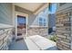 Charming front porch with stone accents leads to the front door, creating a welcoming entrance at 18189 House Finch Ln, Parker, CO 80134