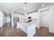 Contemporary kitchen with white cabinets, stainless steel appliances, and a large island for meal prep at 18189 House Finch Ln, Parker, CO 80134