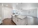 Bright kitchen features white cabinets, granite counters, stainless steel appliances and is open to the living area at 18189 House Finch Ln, Parker, CO 80134