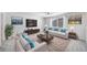 Bright living room is furnished with comfortable seating, media cabinet, and decor for Gathering gatherings at 18189 House Finch Ln, Parker, CO 80134