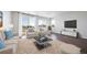 Bright living room with large windows, comfortable seating, and elegant decor, ideal for relaxation at 18189 House Finch Ln, Parker, CO 80134