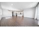 Spacious living room is open to the kitchen and dining area with contemporary flooring and ample natural light at 18189 House Finch Ln, Parker, CO 80134