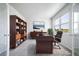 Well-lit office space with a large desk, ample shelving, and a comfortable chair, conducive to productivity at 18189 House Finch Ln, Parker, CO 80134