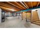 Unfinished basement with exposed beams, concrete floor, and a staircase at 1246 S Routt Way, Lakewood, CO 80232