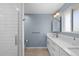 Bathroom with a glass-enclosed shower and dual sink vanity with white countertops at 1246 S Routt Way, Lakewood, CO 80232