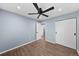 Large bedroom with hardwood floors, a ceiling fan, and ample closet space at 1246 S Routt Way, Lakewood, CO 80232