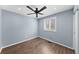 Bedroom featuring hardwood floors, ceiling fan, and window with shutters at 1246 S Routt Way, Lakewood, CO 80232