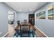 Traditional dining room with table, blue rug, and artwork on the walls at 1246 S Routt Way, Lakewood, CO 80232