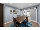 Bright dining room featuring table with chairs, sliding barn door, and artwork at 1246 S Routt Way, Lakewood, CO 80232