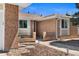 Inviting front entryway featuring brick accents, landscaped surroundings, and a cozy seating area at 1246 S Routt Way, Lakewood, CO 80232