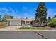 Charming single-story home boasts a well-manicured lawn and attached garage, creating a welcoming curb appeal at 1246 S Routt Way, Lakewood, CO 80232