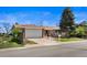 Charming single-story home boasts a well-manicured lawn and attached garage, creating a welcoming curb appeal at 1246 S Routt Way, Lakewood, CO 80232
